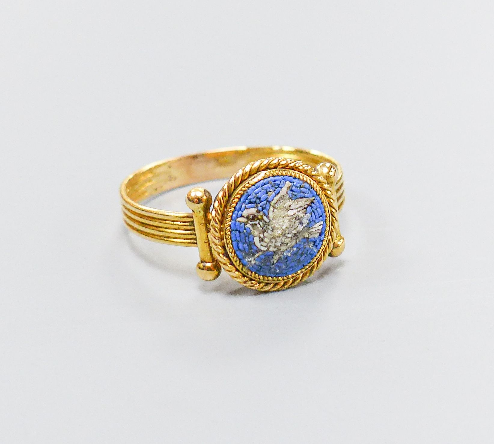 A 19th century Italian? yellow metal and micro mosaic ring, decorated with a dove, size M, gross weight 2.7 grams (a.f.)